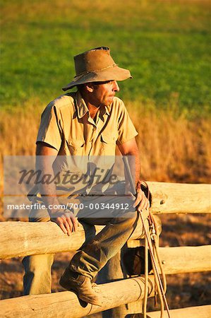 Cowboy Sitting on Fence
