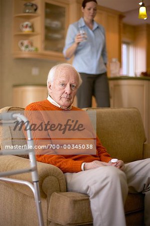 Woman Bringing Man Glass of Water