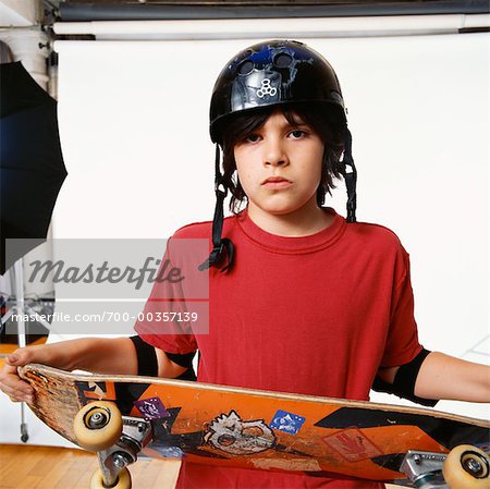 Boy with Skateboard in Studio