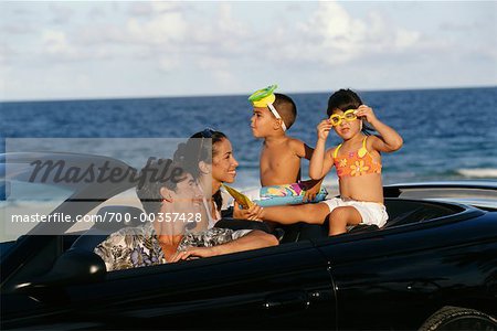 Family Sitting in Convertible at the Beach