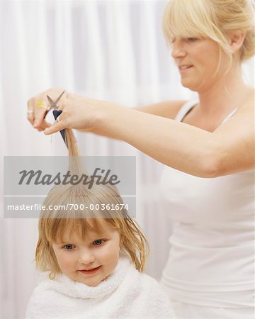 Woman Cutting Child's Hair