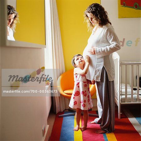 Expectant Mother with Daughter in Nursery