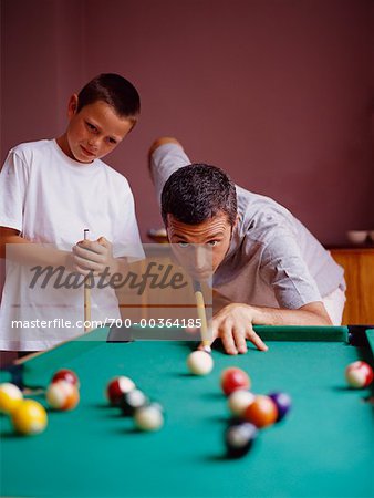 Father and Son Playing Miniature Billiards