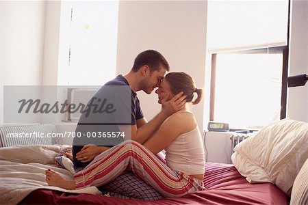 Couple Embracing on Sofa Bed