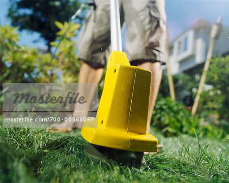 Man Using a Grass Trimmer