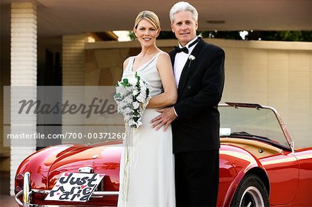 Portrait of Bride and Groom by Car