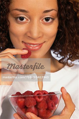 Woman Eating Raspberries