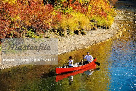 Couple Canoeing Down River Alberta, Canada