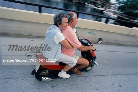 Couple Riding Scooter