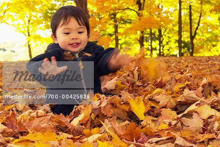 Baby Playing in Leaves