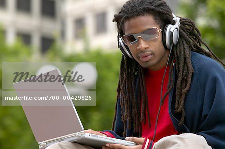 Man with Headphones and Laptop Computer