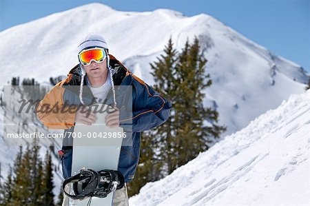 Man on Hill with Snowboard
