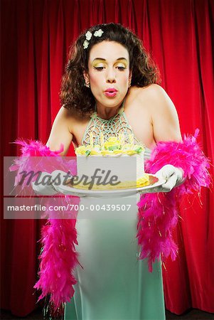 Woman Blowing Out Birthday Candles