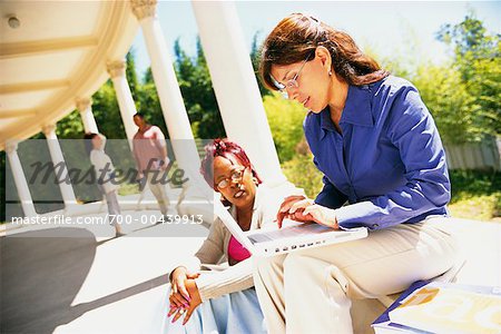 Mature Students Studying Together Outdoors