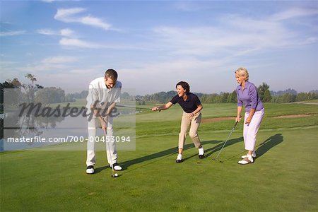 Women and Man Golfing
