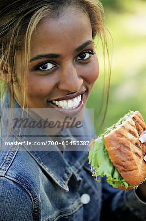 Portrait of a Woman Holding a Sandwich