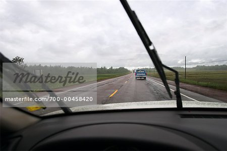 Road in Rain Seen Through Car Windshield