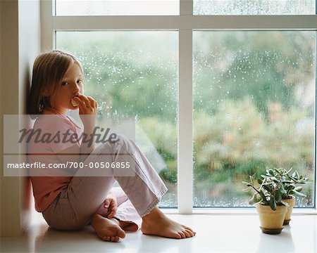 Girl Eating and Looking Out Window