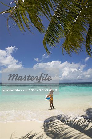 Girl Standing on Tropical Beach, Maldives, Indian Ocean