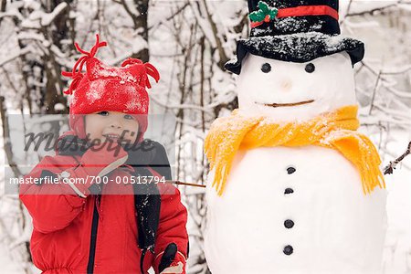 Boy Standing Beside Snowman