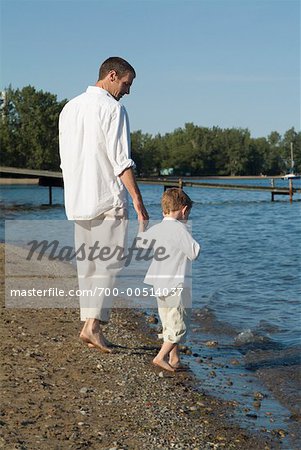 Father and Son Walking on Beach