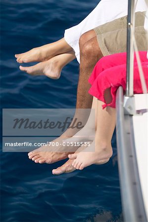 Family Sitting on Edge of Boat