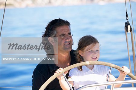 Father and Daughter Steering Boat
