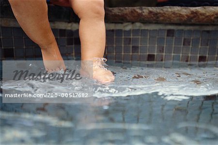Baby's Feet Dangling Over Side of Pool