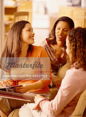 Girlfriends Hanging Out and Looking at Scrapbook