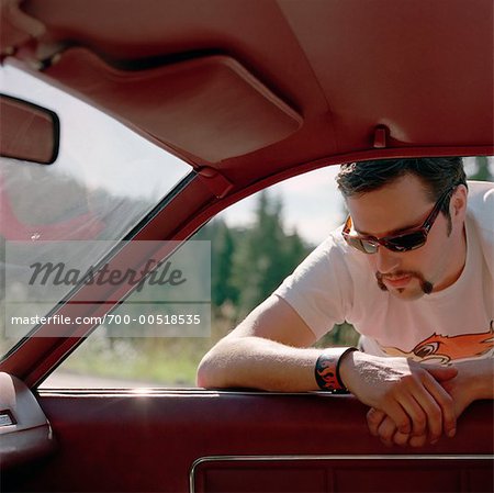 Man Leaning on Car