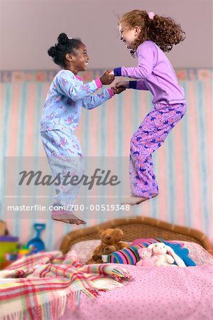 Children Jumping on Bed
