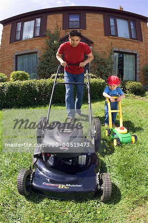 Father and Son Mowing the Lawn