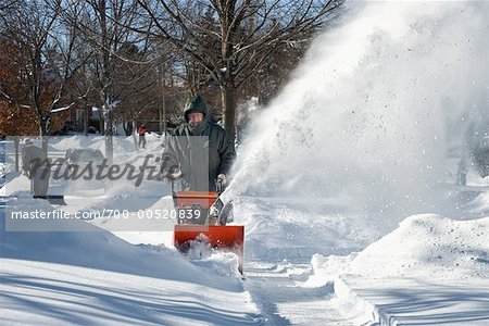 Man Operating a Snowblower