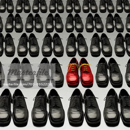Red Shoes Among Rows of Black Shoes