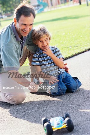 Father and Son Playing With Remote Controlled Car