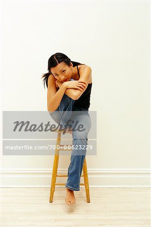Portrait of Woman Sitting On a Stool