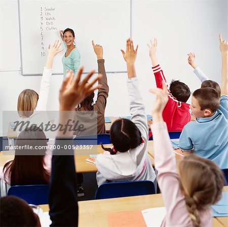 Students with Hands Raised in Classroom