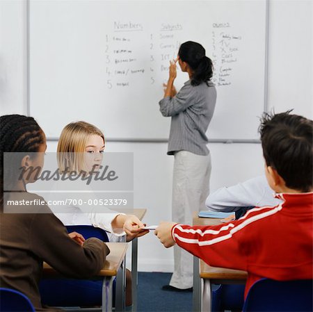 Students Passing A Note in the Classroom