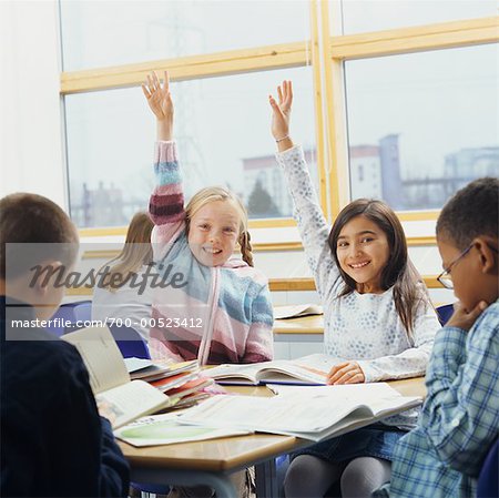 Girls Raising Hands in Classroom