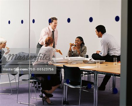 Business People Eating Pizza in Boardroom