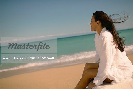 Woman Sitting by the Ocean