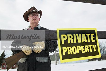 Man Guarding Property with a Shotgun