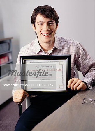 Portrait of Businessman Holding Certificate