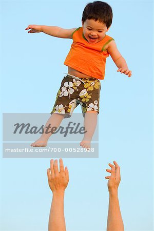 Father Lifting Son in Air