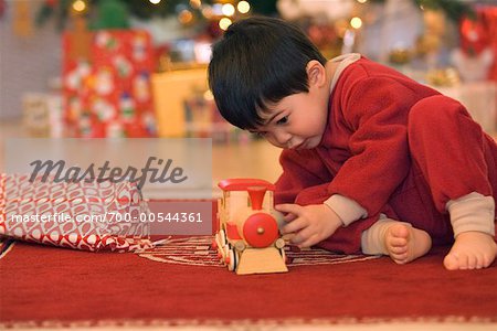 Garçon jouant avec le petit Train le matin de Noël