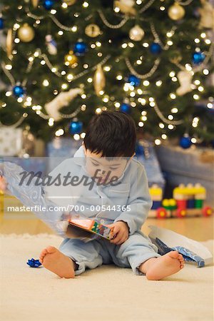 Boy Opening Gift on Christmas Morning