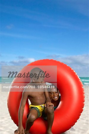Boy and Girl with Inner Tube on Beach