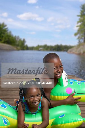 Boy and Girl with Inflatable Toy On Dock