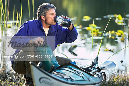 Man Drinking From Water Bottle on Kayak Trip