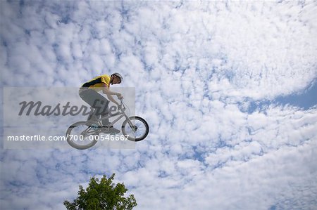 Man Jumping on Bicycle